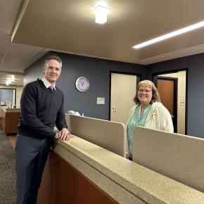 Dr. Adam Mues standing in hallway with nurse Robin